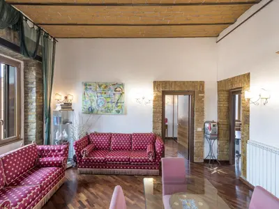 a living room with red couches and a television at Apartment Lucilla Home by Interhome in Rome