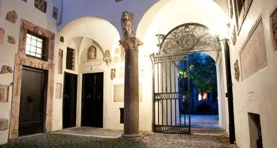 a building with stairs in front of a door at House-Museum Palazzo Podocataro in Rome