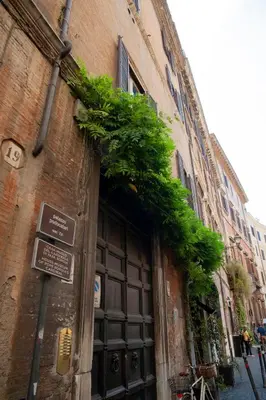 an entrance to a building with an open gate at House-Museum Palazzo Podocataro in Rome