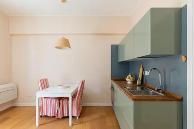 a kitchen with a sink and a small table at Gianicolo - Homkeey Apartments in Rome