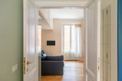 an open door to a living room with a blue couch at Gianicolo - Homkeey Apartments in Rome