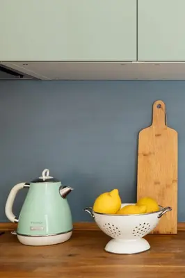 a bowl of lemons and a tea kettle on a counter at Gianicolo - Homkeey Apartments in Rome