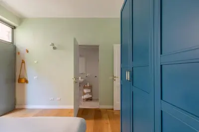 a bedroom with a blue door and a bathroom at Gianicolo - Homkeey Apartments in Rome