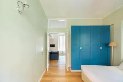 a bedroom with a blue cabinet and a bed at Gianicolo - Homkeey Apartments in Rome