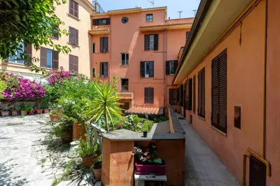 a courtyard in a building with flowers and plants at Gianicolo - Homkeey Apartments in Rome
