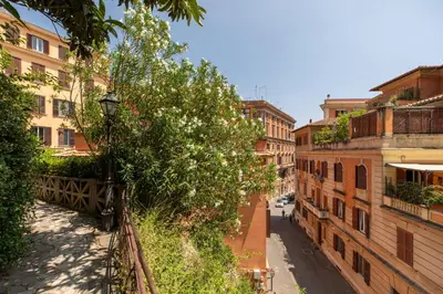 an empty street in a city with buildings at Gianicolo - Homkeey Apartments in Rome