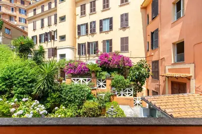 a view of a building with flowers and plants at Gianicolo - Homkeey Apartments in Rome