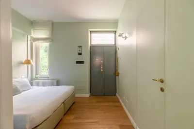 a bedroom with a bed and a window and a door at Gianicolo - Homkeey Apartments in Rome