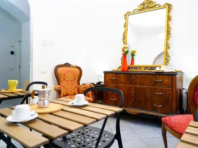 a dining room with a table and a mirror at Salotto Piramide in Rome