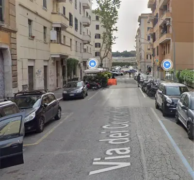 a street with cars parked on the side of the road at Salotto Piramide in Rome
