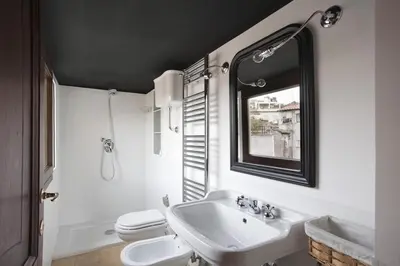 a bathroom with a sink and a toilet and a window at Laurina F2 roof terrace - LOCAPPART in Rome