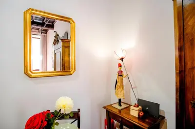a room with a mirror and a dress on a table at Elegantis Eat Pray and Love in Rome - Near Navona Square and Campo de' Fiori in Rome