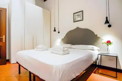a bedroom with a large white bed with towels on it at Elegantis Eat Pray and Love in Rome - Near Navona Square and Campo de' Fiori in Rome