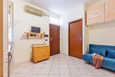 a living room with a table and a blue couch at Casina Roxy in Rome