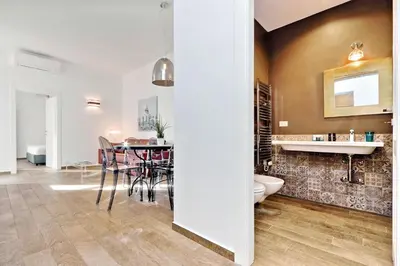 a kitchen and dining room with a table and chairs at Monti Apartments - My Extra Home in Rome