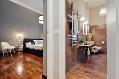 a bathroom with a bed and a sink in a room at Monti Apartments - My Extra Home in Rome