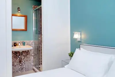 a bathroom with a bed and a shower and a sink at Monti Apartments - My Extra Home in Rome