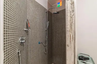 a bathroom with a shower and a sink at GuestHost - Cozy Ostiense Flat with Terrace! in Rome