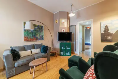 a living room with a couch and a tv at GuestHost - Cozy Ostiense Flat with Terrace! in Rome