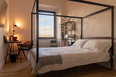 a bedroom with a canopy bed with a window at Cunabu Giolitti 12 in Rome