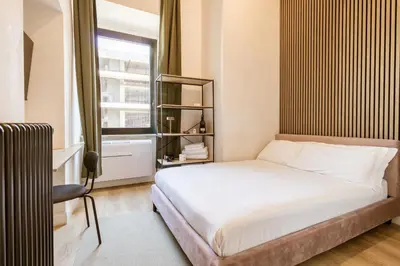 a small bedroom with a bed and a window at Cunabu Giolitti 12 in Rome