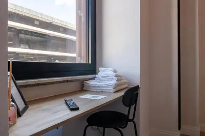 a room with a desk with a chair and a window at Cunabu Giolitti 12 in Rome