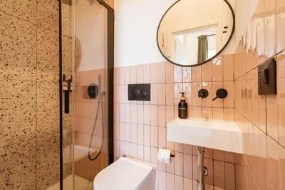 a bathroom with a toilet and a sink and a mirror at Cunabu Giolitti 12 in Rome