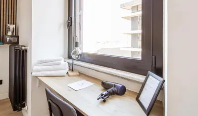 a desk with a camera on it next to a window at Cunabu Giolitti 12 in Rome