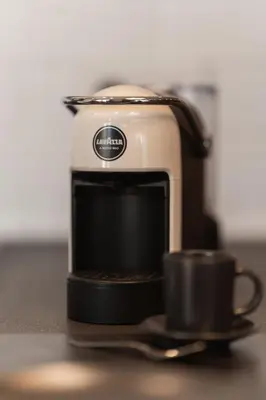 a coffee maker with a cup on a counter at In Trastevere Luxury in Rome