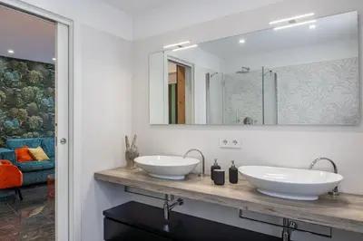 a bathroom with two sinks and a mirror at In Trastevere Luxury in Rome