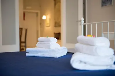 a stack of towels sitting on top of a table at Authentic Sweet Home in Rome