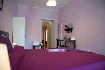 a purple bedroom with a bed with a purple blanket at Authentic Sweet Home in Rome