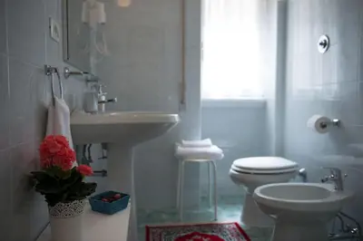 a white bathroom with a sink and a toilet at Authentic Sweet Home in Rome