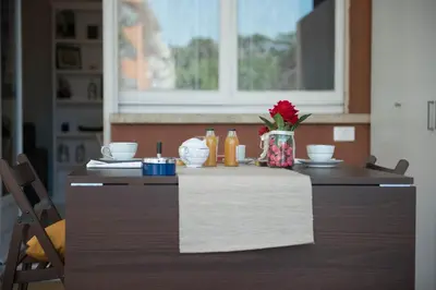 a table with a vase of flowers on top of it at Authentic Sweet Home in Rome