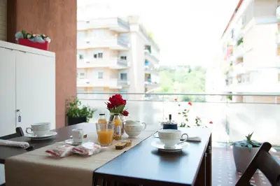 a table with cups and drinks on a balcony at Authentic Sweet Home in Rome
