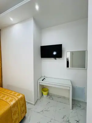 a bedroom with a desk and a tv on the wall at Acropoli in Rome