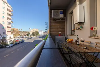 a balcony with a table and chairs and a street at Trastevere 2Rooms with Balcony in Rome