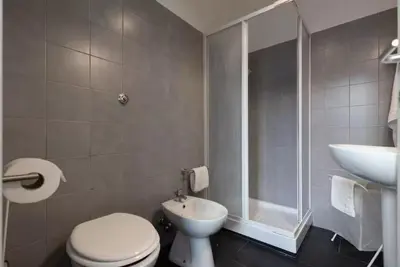 a bathroom with a toilet and a shower and a sink at Trastevere 2Rooms with Balcony in Rome