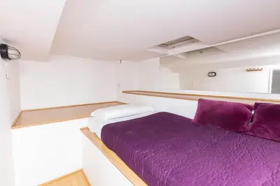 a small bedroom with a purple bed in it at Fontana di Trevi Modern Apartment in Rome