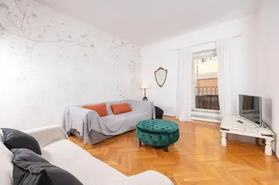 a living room with a couch and a tv at Fontana di Trevi Modern Apartment in Rome