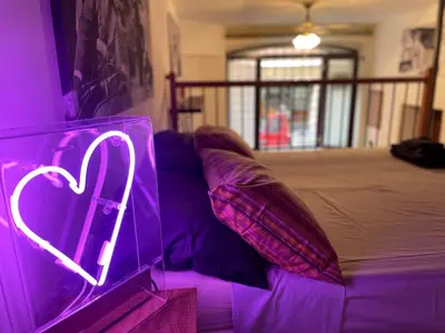 a purple couch with a heart sign on it at Bnb cuore di Roma in Rome