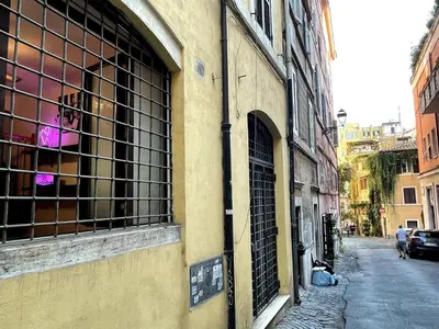 a building with a barred window on a street at Bnb cuore di Roma in Rome