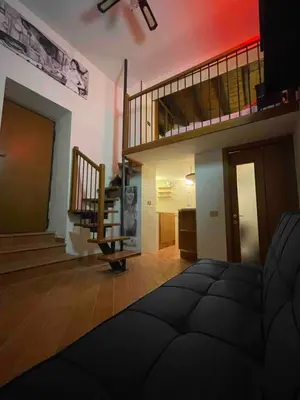 a living room with a staircase and a stair case at Bnb cuore di Roma in Rome