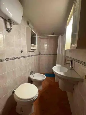a bathroom with a toilet and two sinks in it at Bnb cuore di Roma in Rome