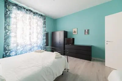 a bedroom with a bed and a large window at MV Vatican House in Rome in Rome