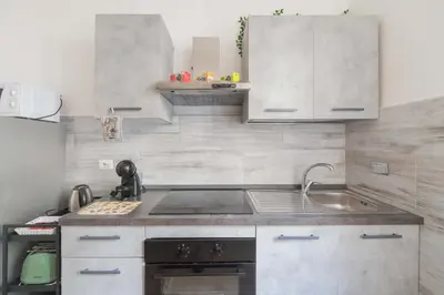 a small kitchen with a sink and a stove at MV Vatican House in Rome in Rome
