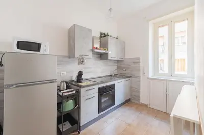 a white kitchen with a refrigerator and a sink at MV Vatican House in Rome in Rome