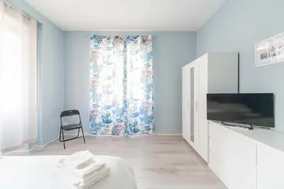 a room with a bed and a tv and a chair at MV Vatican House in Rome in Rome
