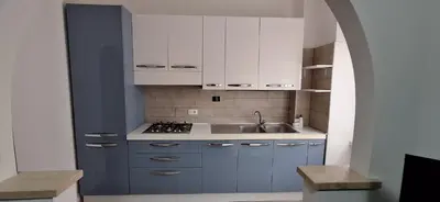 a kitchen with white cabinets and a sink at IN love with rome gemelli e vaticano in Rome