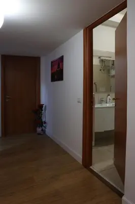 a hallway with a door open to a kitchen at IN love with rome gemelli e vaticano in Rome